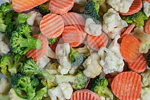Heap of frozen vegetable mix close-up on a white background. Isolated