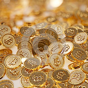 Heap of gold coins with bitcoin sign.