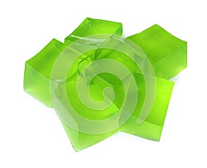 Heap of green jelly cubes on background