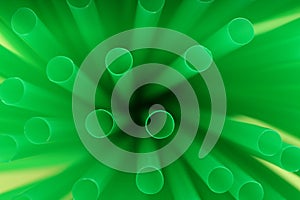 Heap of green plastic straws for drinks, closeup