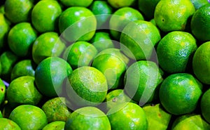 Heap of green sweet lime for sale in market