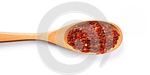 Heap Of Ground Paprika In Wooden Spoon On White Background. Pile Of Spice Red Pepper Flakes. Top View Of Spicy Chili