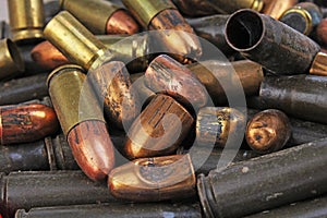 Heap of gun bullets. Weapon Cartridge case sleeve background texture, 7.65, and 9mm. Weapon cartridge sleeves.Gun bullet