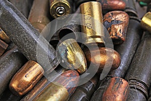 Heap of gun bullets. Weapon Cartridge case sleeve background texture, 7.65, and 9mm. Weapon cartridge sleeves.Gun bullet pattern c