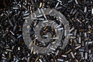 Heap of gun bullets. Weapon Cartridge case sleeve background texture, 9mm. Weapon cartridge sleeves.Gun bullet pattern close up photo