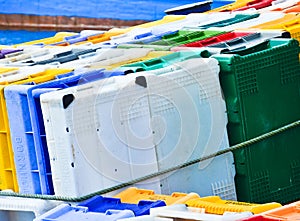 A heap, a huddle of traditional fishing equipement with colourful plastic boxes