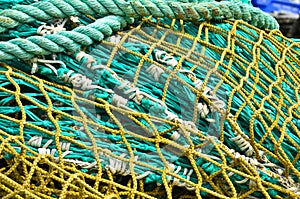 A heap, a huddle of traditional fishing equipement with green nets and orange buoys