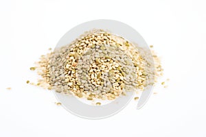 a heap of hulled hemp seeds on a white surface