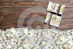 Heap of hundred Dollar Bills on colored background top view, with empty place for your text business money concept