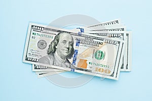 Heap of hundred dollars. Modern 100 us dollar bills on blue background