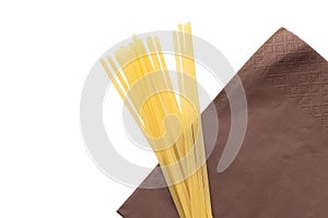 Heap of italian macaroni spaghetti on brown napkin