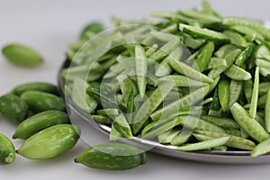 Heap of Ivy gourd or Kovaka vegetables, meticulously sliced lengthwise photo