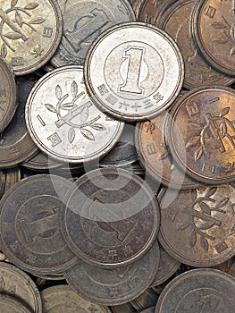 Heap of Japanese coins at 1 yen. News about the economy, finances and interest rate of the central bank of Japan. External and