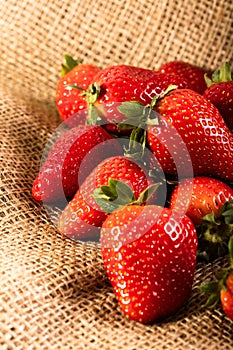 Heap of juicy strawberry on the jute bag