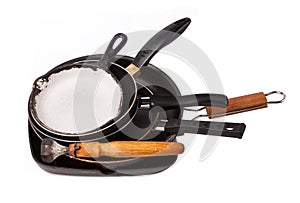 Heap of kitchen bakeware with pan and pot