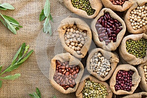 Heap of Legumes seeds with nut leaf top view