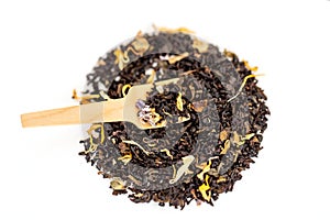 Heap of loose leaf black and green tea blend isolated on a white