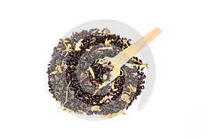 Heap of loose leaf black and green tea blend isolated on a white