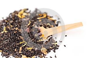 Heap of loose leaf black and green tea blend isolated on a white