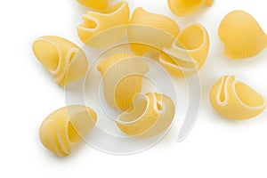 Heap of macaroni shells, selective focus. Isolated on white