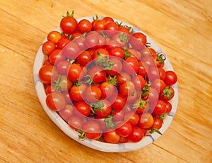 Heap of many small red ripe cherry tomatoes