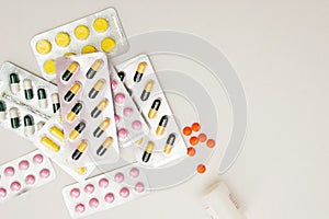 Heap of medical pills in yellow, pink and green colors. Pills in plastic package.