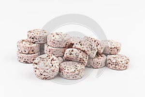 Heap of medicine colored pills, tablets on a white background