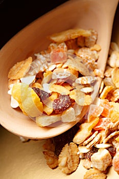 Heap of musli with raisin in wooden spoon