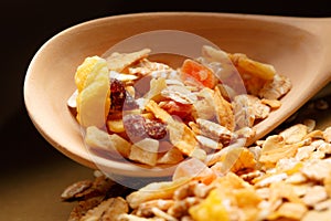 Heap of musli with raisin in wooden spoon