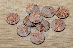 Heap of old antique Dutch VOC coins from 1789 on a wooden background