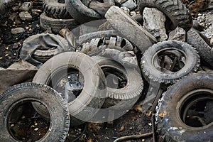 Heap of old car junk tires, used truck rubbish wheels, industrial garbage