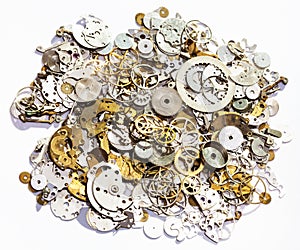 Heap of old watch spare parts on white background