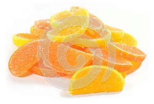 Heap of orange and lemon candy slices on a white