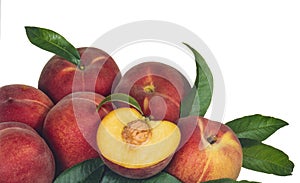 heap of peaches, with one cut in half on a white background