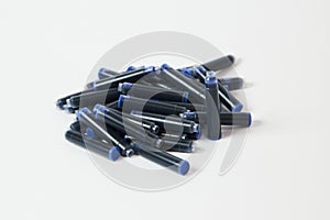 A heap of pen cartridges with blue ink