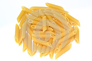 Heap of penne rigate pasta on white background