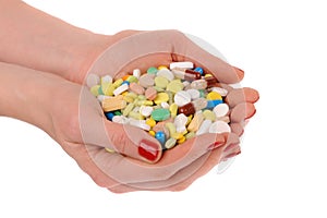 Heap of pills in the hands over white background