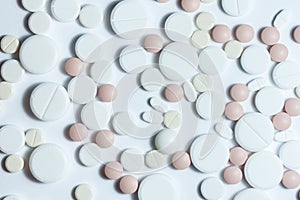 Heap of pills, pharmaceutical medicine tablets and capsules on white background. Drug prescription for treatment medication health