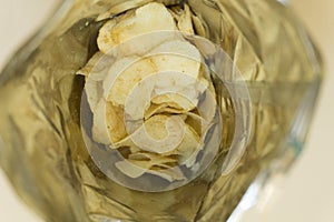 Heap of potato crisps on white background .