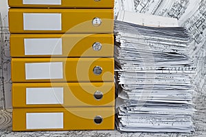 Heap of project drawings in yellow folder.