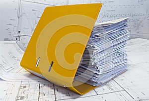 Heap of project drawings in yellow folder.