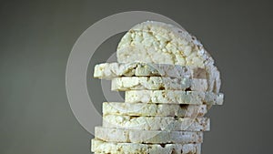 Heap of Puffed rice cakes with oat flakes and bran, close-up. Rotation motion. Crusty rice bread.