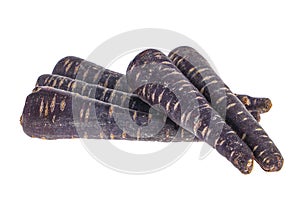 Heap of purple carrots isolated on white background, one cut through