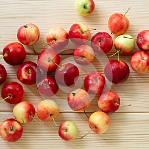 Heap of ranetki on a light wooden background
