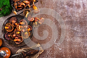 Heap of raw wild saffron milk cap or red pine mushrooms on plate