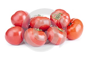 Heap of ripe, fresh tomatoes close up on a white background