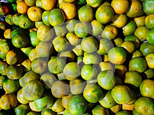 Heap of ripe green yellow sweet lemon mosambi lebu for sale in fruit market