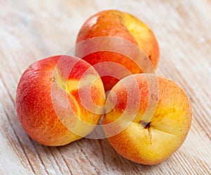 Heap of ripe reddish apricots on wooden table