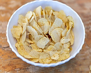 Heap of rippled chips in bowl