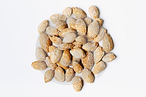Heap of roasted almond nuts on white